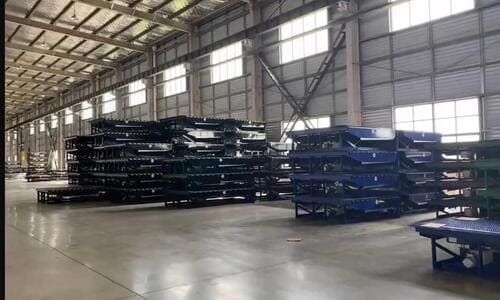 Warehouse storage with multiple GEAJIE heavy-duty hydraulic dock levelers in inventory, prepared for quick wholesale delivery