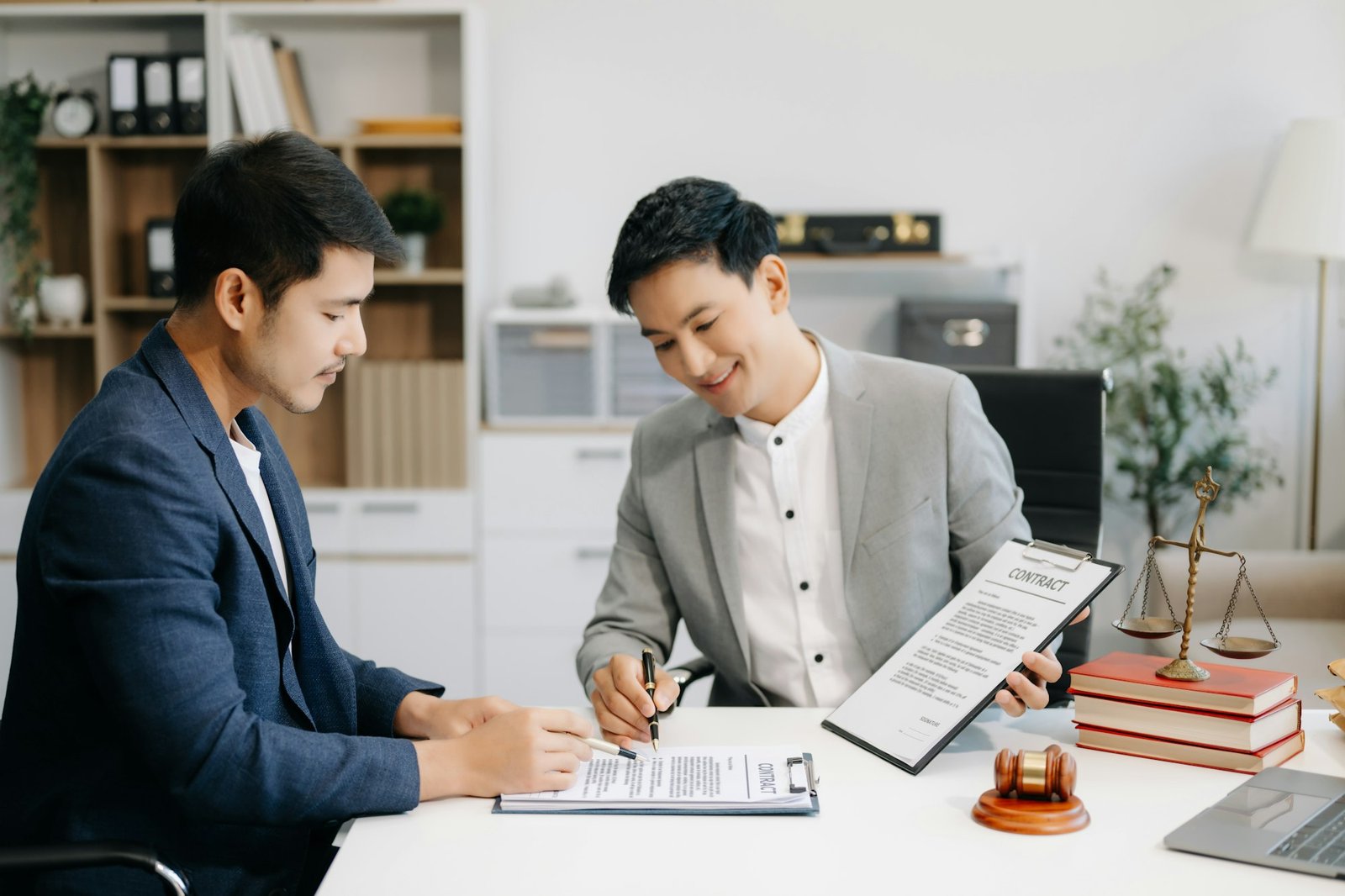 Business people compassionately holding hands and discussing contract papers