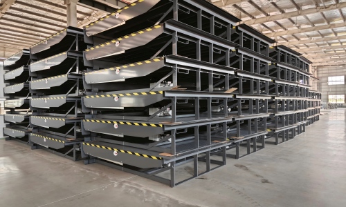 Neatly arranged rows of blue and gray GEAJIE hydraulic dock levelers in large warehouse inventory